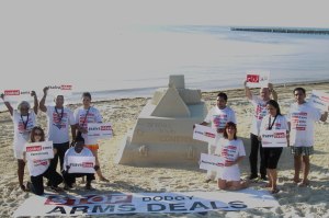 Dr. Bob Mtonga and colleagues from Control Arms say "Save Lives" with sand sculpture at ATT mtg Cancun.